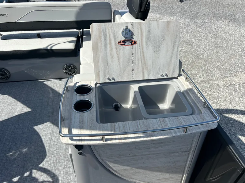 Slide: The Image of The 2027 Harris Grand Mariner 250 features an outdoor kitchenette with a double sink and cup holders. - 19