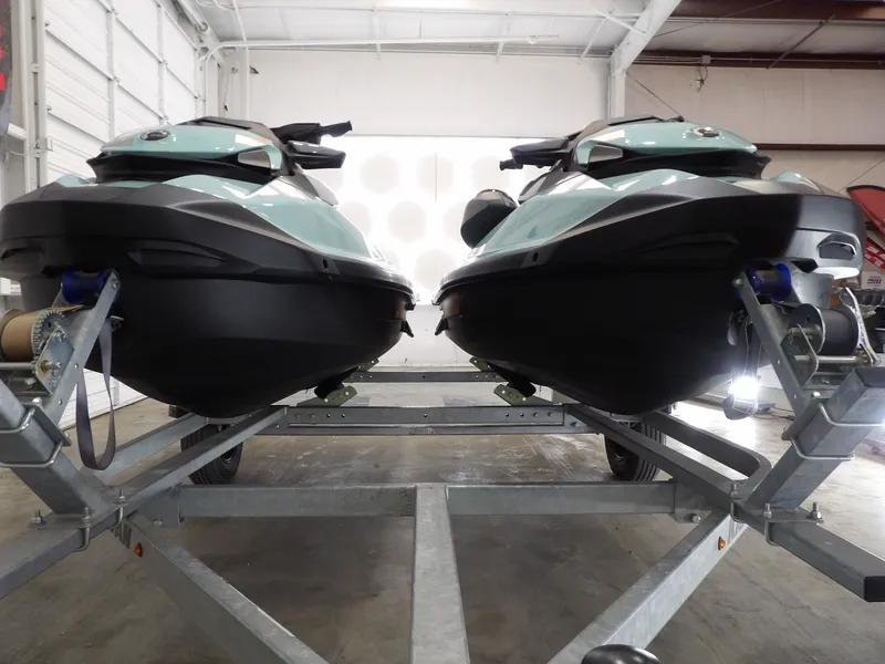 Slide: The Image of Two 2023 Sea-Doo Wake 170 jet skis on trailer in garage. - 6