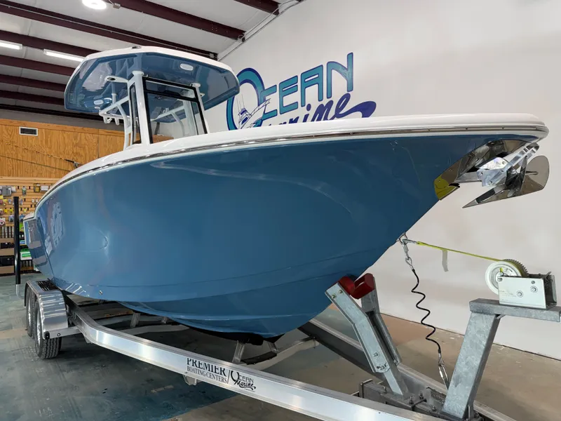Slide: The Image of 2026 Tidewater 232 CC Adventure boat in a showroom on a trailer. - 11