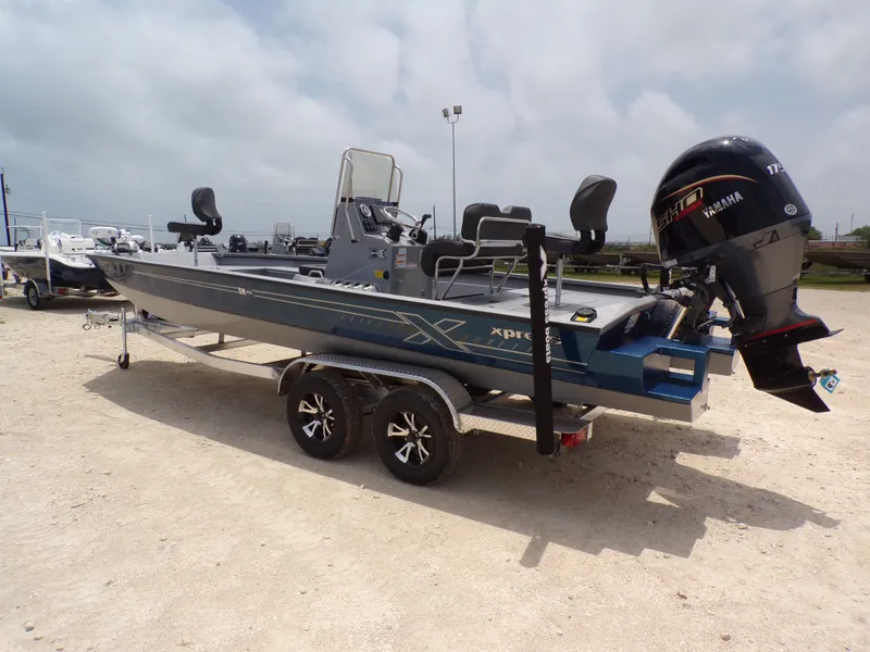 Slide: The Image of 2026 Xpress SW22B boat with Yamaha engine on trailer. - 14