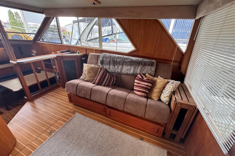 Slide: The Image of Luxurious interior of 1987 Chris-Craft 44 Commander yacht with plush seating and wooden accents. - 10
