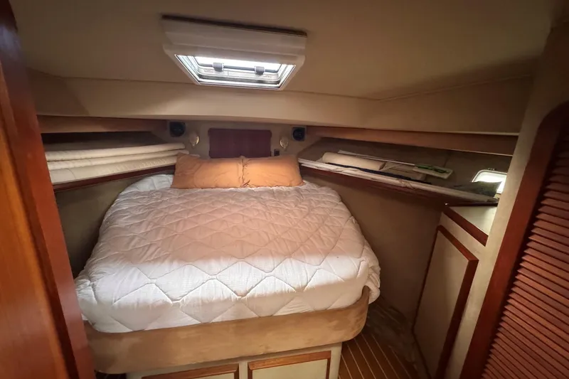 Slide: The Image of 1987 Chris-Craft 44 Commander cabin with cozy bed and wooden interior. - 15