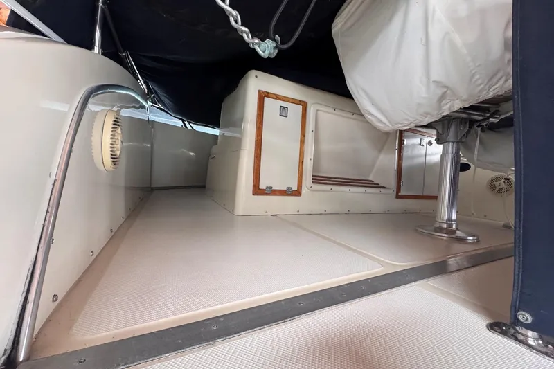Slide: The Image of Interior view of 1987 Chris-Craft 44 Commander boat, showcasing storage and seating area. - 16