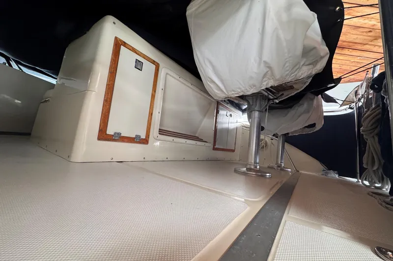 Slide: The Image of 1987 Chris-Craft 44 Commander interior with covered seating and storage compartments. - 17