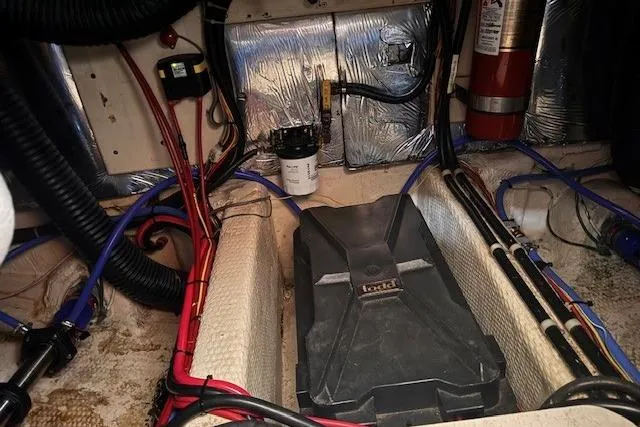 Slide: The Image of Engine room of 1987 Chris-Craft 44 Commander with wiring and fire extinguisher. - 19