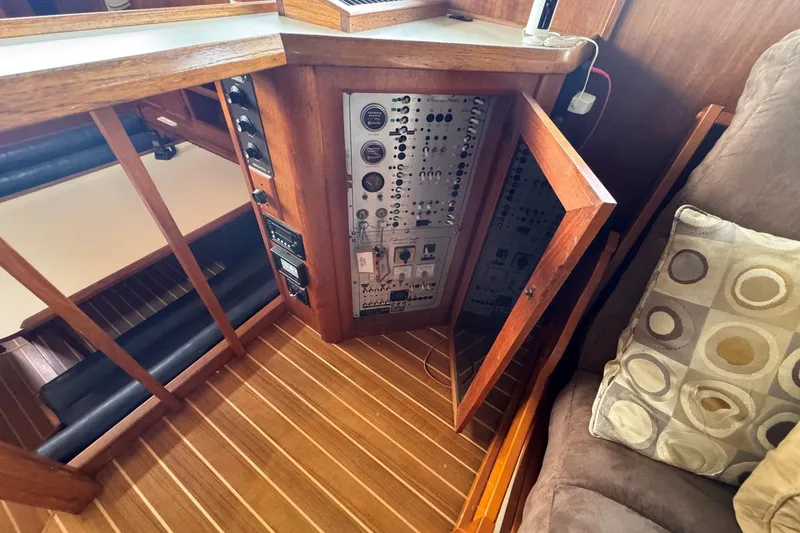 Slide: The Image of Electrical panel inside a 1987 Chris-Craft 44 Commander yacht, featuring wood accents and modern controls. - 20