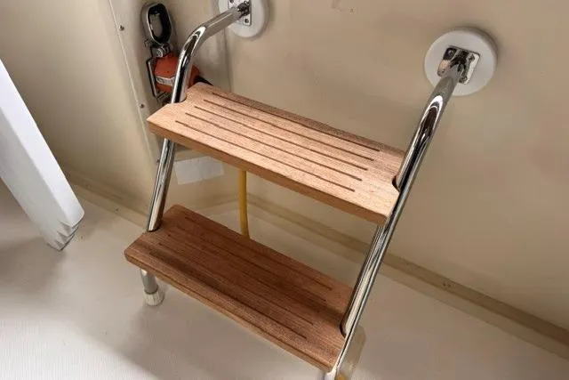 Slide: The Image of Sturdy wooden steps with metal rails on a 1987 Chris-Craft 44 Commander boat. - 6