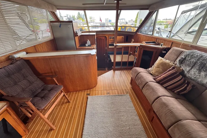 Slide: The Image of Luxurious interior of a 1987 Chris-Craft 44 Commander yacht with wood accents and plush seating. - 8