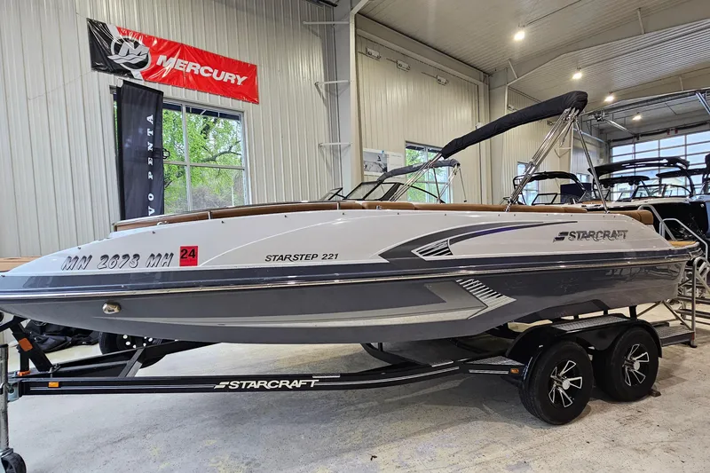 The Image of 2022 Starcraft Star Step 221 E I/O boat on trailer in showroom. - 1