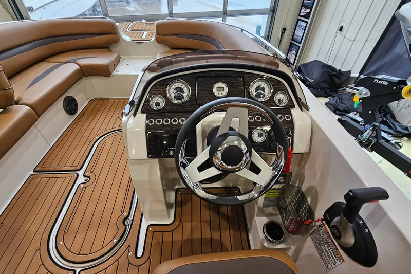 Slide: The Image of 2022 Starcraft Star Step 221 E I/O boat interior with sleek dashboard and wood-style flooring. - 12