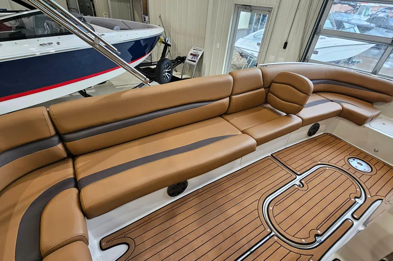 Slide: The Image of 2022 Starcraft Star Step 221 E I/O boat interior with tan seating and wood-style flooring. - 13