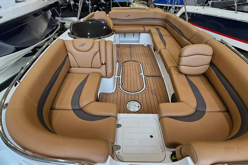 Slide: The Image of 2022 Starcraft Star Step 221 E I/O boat interior with tan leather seating and wood flooring. - 14