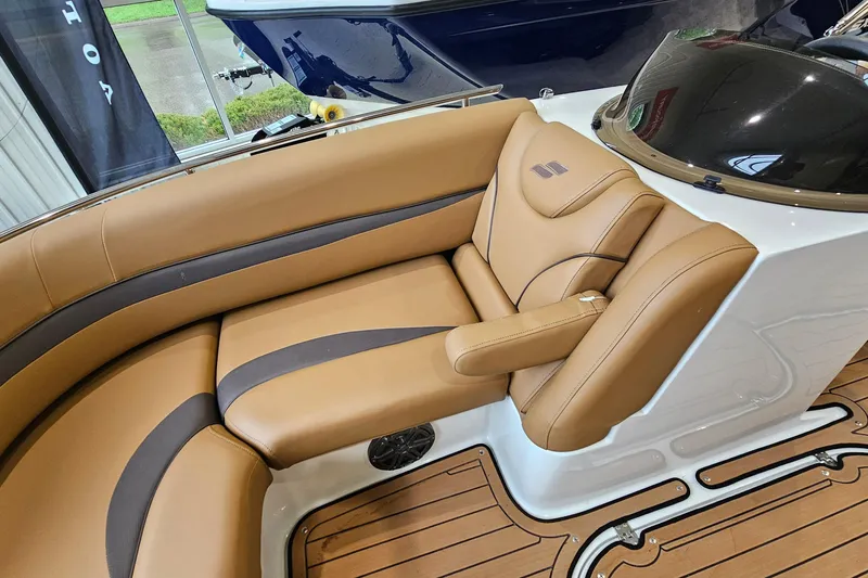 Slide: The Image of 2022 Starcraft Star Step 221 E I/O boat interior with tan leather seating and wood flooring. - 17