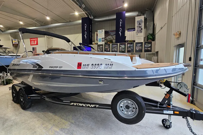 Slide: The Image of 2022 Starcraft Star Step 221 E I/O boat on trailer in showroom. - 2