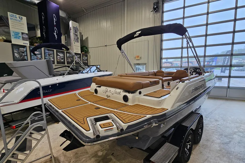 Slide: The Image of 2022 Starcraft Star Step 221 E I/O boat displayed in showroom with sleek design. - 4