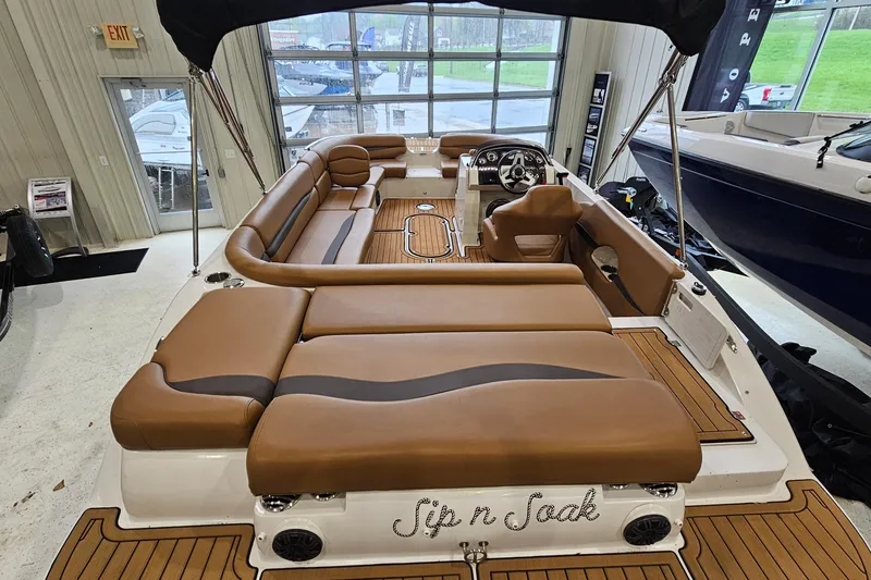 Slide: The Image of 2022 Starcraft Star Step 221 E I/O boat with luxurious brown seating and sleek interior design. - 5