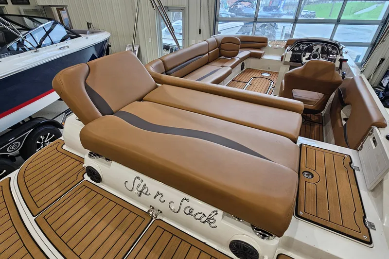 Slide: The Image of 2022 Starcraft Star Step 221 E I/O boat interior with luxurious brown seating and wood accents. - 6