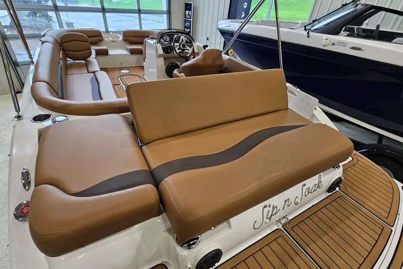 Slide: The Image of 2022 Starcraft Star Step 221 E I/O boat interior with tan seating and wood accents. - 7