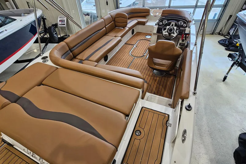 Slide: The Image of 2022 Starcraft Star Step 221 E I/O boat interior with brown seating and wood flooring. - 8