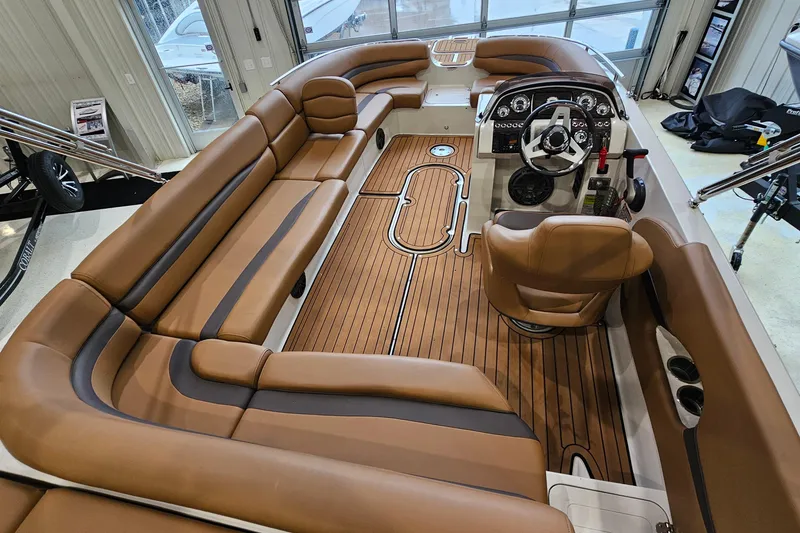 Slide: The Image of 2022 Starcraft Star Step 221 E I/O boat interior with brown seating and wood flooring. - 9