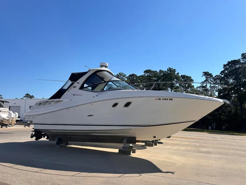 The Image of 2007 Sea Ray Sundancer 310 on a lot under clear blue sky. - 0