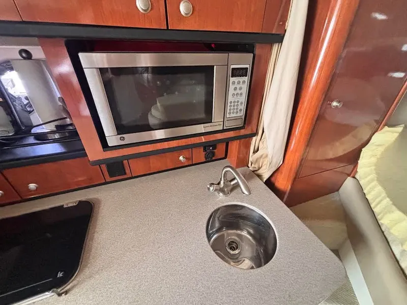 Slide: The Image of Sea Ray Sundancer 310 kitchen area with microwave and sink, 2007 model. - 17