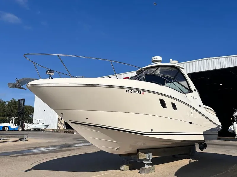 Slide: The Image of 2007 Sea Ray Sundancer 310 on a boat lift outside a storage facility. - 2