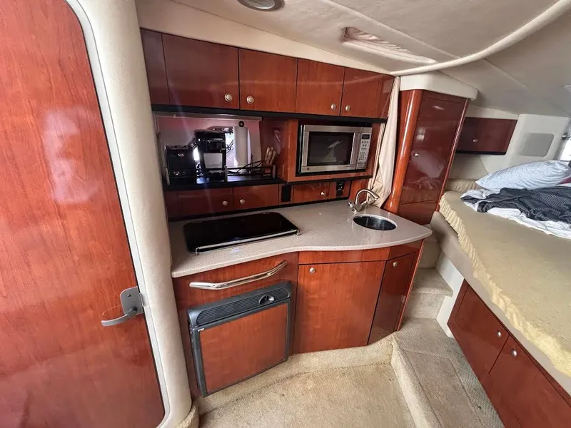 Slide: The Image of Interior of 2007 Sea Ray Sundancer 310 yacht with kitchen and sleeping area. - 26