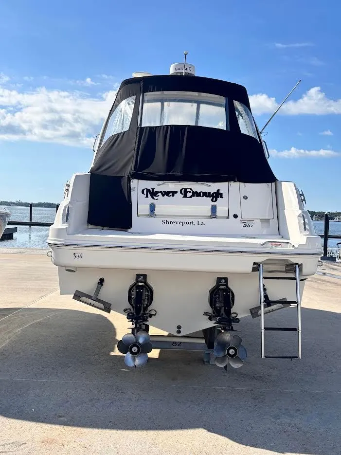 Slide: The Image of 2007 Sea Ray Sundancer 310 boat docked under blue sky. - 32
