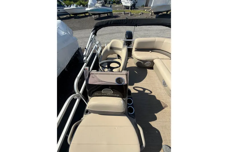 Slide: The Image of 2021 Sun Tracker Bass Buggy 16 XL Select pontoon boat interior with beige seating. - 15