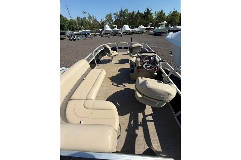 Slide: The Image of 2021 Sun Tracker Bass Buggy 16 XL Select pontoon boat with beige seating and steering console. - 20