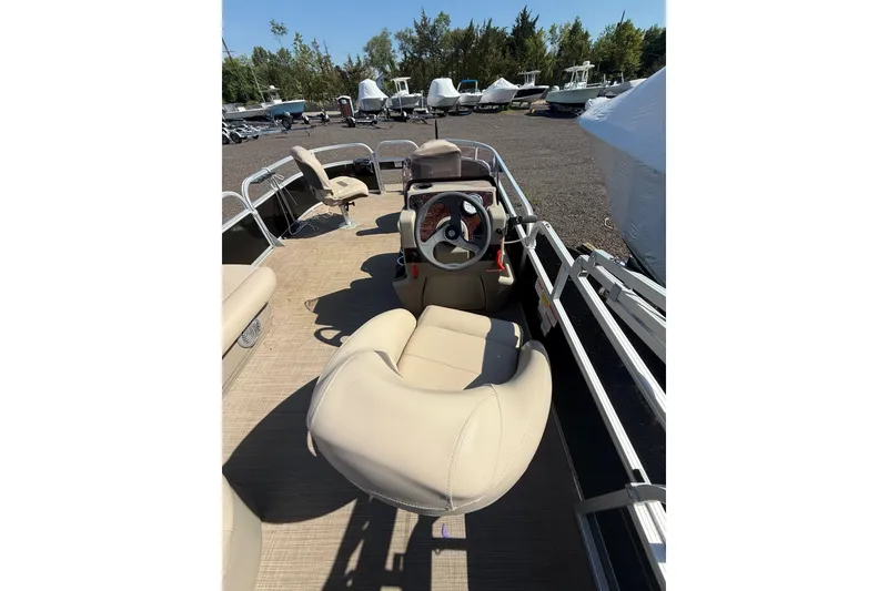 Slide: The Image of 2021 Sun Tracker Bass Buggy 16 XL Select pontoon boat interior with beige seating. - 21