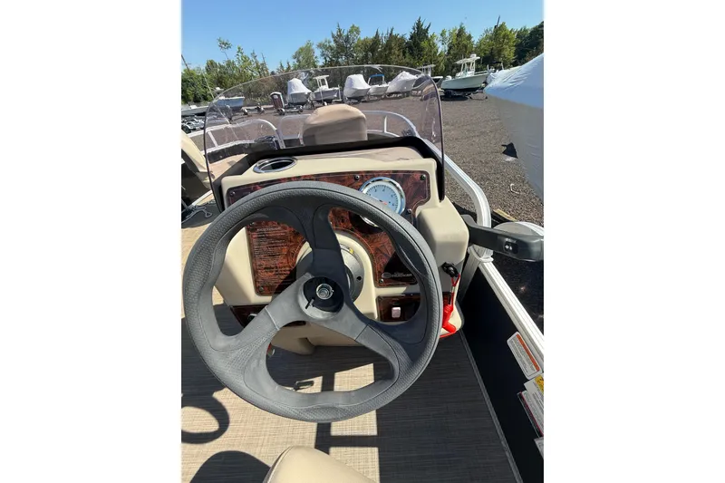 Slide: The Image of 2021 Sun Tracker Bass Buggy 16 XL Select steering console with clear windshield and gauge. - 22
