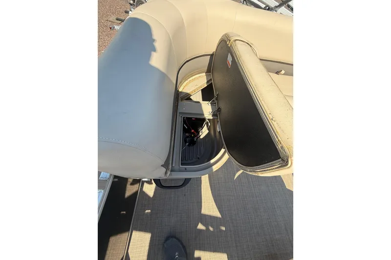 Slide: The Image of 2021 Sun Tracker Bass Buggy 16 XL Select boat seat storage compartment open. - 24