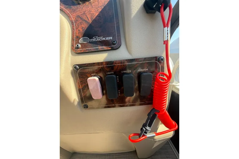 Slide: The Image of Control panel of 2021 Sun Tracker Bass Buggy 16 XL Select with switches and safety lanyard. - 27