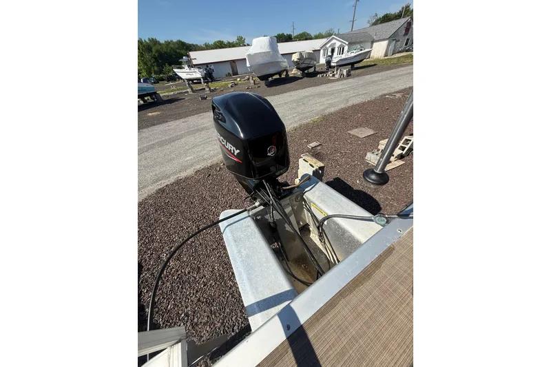 Slide: The Image of 2021 Sun Tracker Bass Buggy 16 XL Select with Mercury outboard motor in a boatyard. - 28