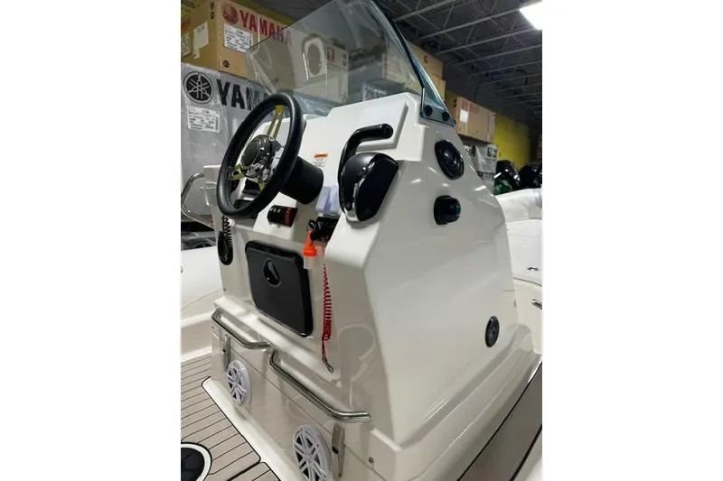 Slide: The Image of Control console of a 2025 Zodiac Medline 7.5 boat with steering wheel and controls. - 12