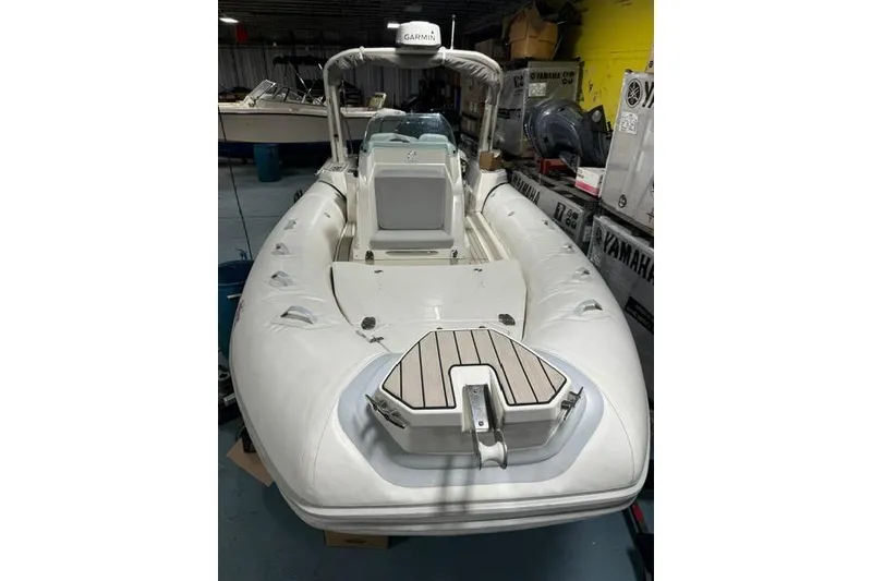 Slide: The Image of 2025 Zodiac Medline 7.5 inflatable boat in showroom, featuring Garmin equipment and Yamaha accessories. - 7
