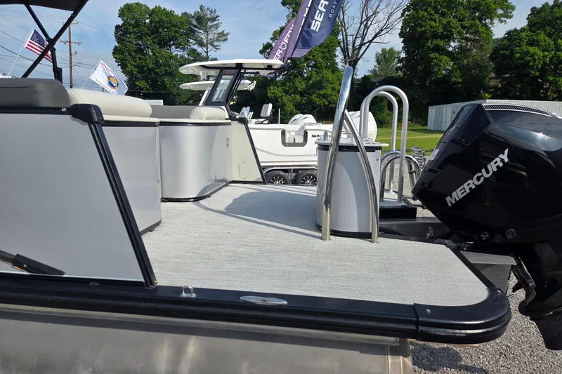Slide: The Image of 2021 Avalon 2585 Catalina QL pontoon boat with Mercury engine, displayed outdoors. - 10