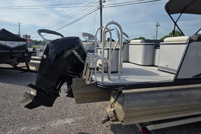 Slide: The Image of 2021 Avalon 2585 Catalina QL pontoon boat with Mercury outboard motor, parked outdoors. - 11