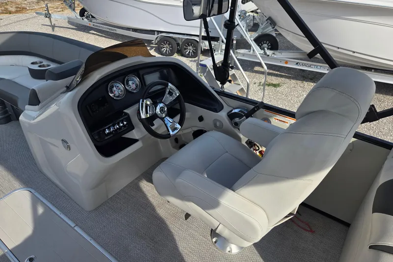 Slide: The Image of 2021 Avalon 2585 Catalina QL boat interior with steering console and plush seating. - 6
