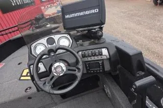 Slide: The Image of 2022 Alumacraft Competitor 165 SC boat dashboard with steering wheel and Humminbird electronics. - 3