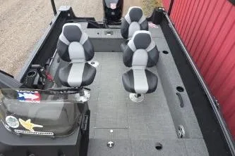 Slide: The Image of 2022 Alumacraft Competitor 165 SC boat interior with four seats and a windshield. - 4