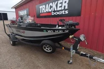 Slide: The Image of 2022 Alumacraft Competitor 165 SC boat on trailer near Tracker Boats sign. - 7