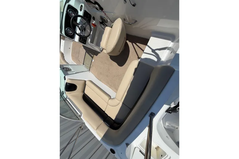 Slide: The Image of Interior view of 2016 Hurricane SunDeck 187 OB boat with beige seating and steering console. - 3