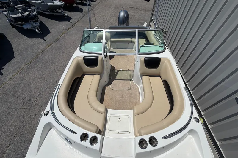 Slide: The Image of 2016 Hurricane SunDeck 187 OB boat with beige seating and open deck layout. - 5
