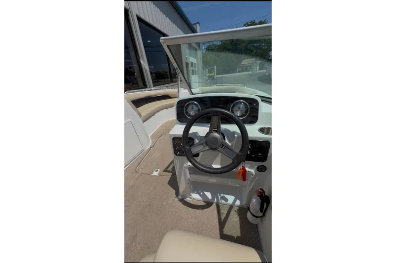 Slide: The Image of 2016 Hurricane SunDeck 187 OB boat cockpit with steering wheel and gauges. - 7