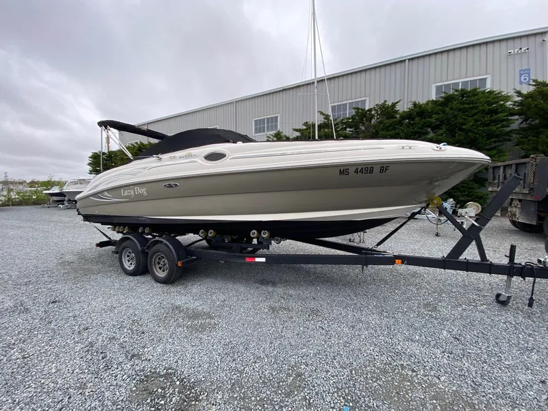 The Image of 2006 Sea Ray 240 Sundeck boat on trailer outdoors. - 0