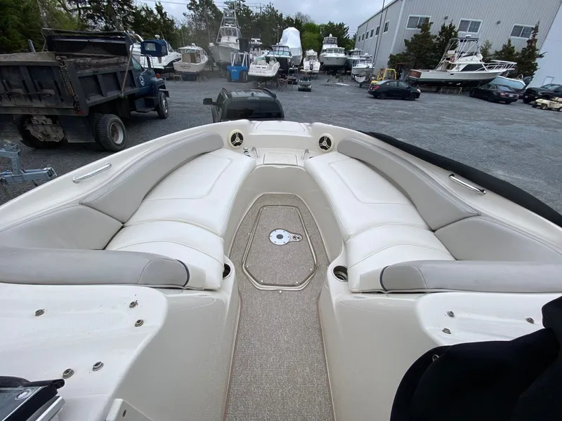 Slide: The Image of Interior view of a 2006 Sea Ray 240 Sundeck boat in a marina. - 10