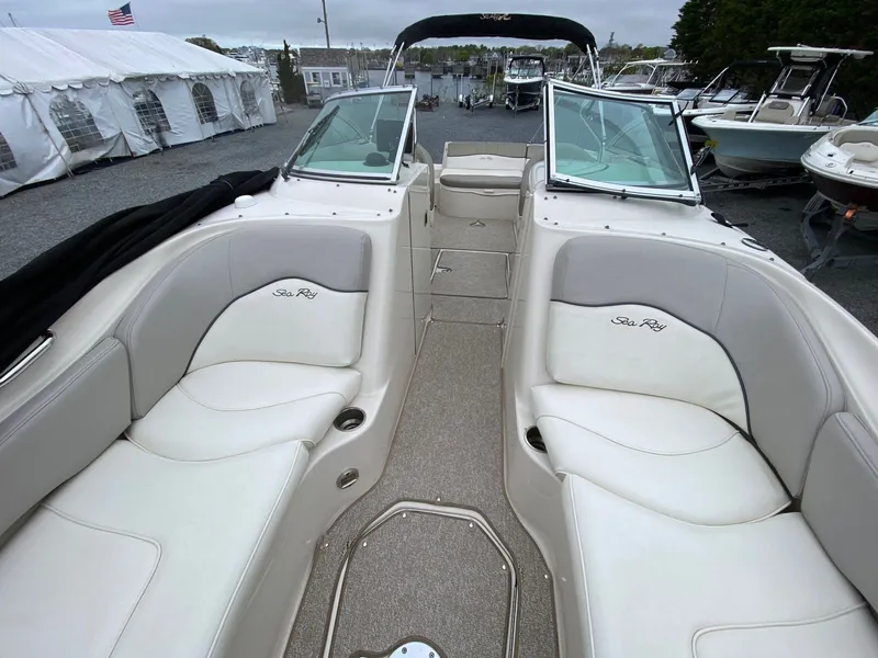 Slide: The Image of Interior of a 2006 Sea Ray 240 Sundeck boat with white seating. - 11
